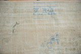 Distressed texture of a vintage Oushak rug with mostly even wear across its knot heads.