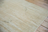 The reverse of a vintage Oushak rug, showing its hand-knotted foundation and processing marks.