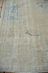 Textural wear on the hand-knotted pile of a vintage distressed Turkish Oushak rug.