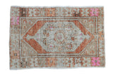 Distressed Oushak rug with lozenge medallion, floral designs, faded rust, beige, hot pink.