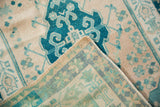 Distressed Oushak rug pile in teal and ivory, with faint foundation and reverse weave.