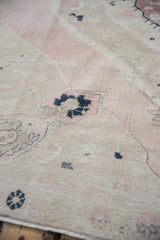 Vintage distressed Oushak pile with even wear and dusty mauve, ivory shades.