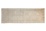 Vintage Turkish Oushak rug runner, hand-knotted, with faded floral medallion and abrashed ivory field, 3x8'8