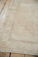 Reverse view of distressed Oushak runner foundation, cotton selvage, light rippling, faint markings.
