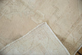 Distressed ivory Oushak runner with visible wear to pile and hand-knotted foundation.