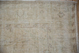 Vintage Distressed Oushak carpet corner with worn pile, visible foundation, and intact selvage.