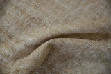 Distressed Oushak carpet surface, with worn knot heads and visible foundation.