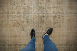 Distressed Oushak carpet, worn pile with faded floral patterns in ivory and seafoam.