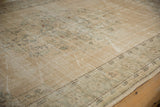 Distressed vintage Oushak carpet with worn texture, visible foundation, and muted floral patterns.