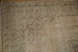 Worn antique ivory pile and exposed foundation on a distressed vintage Oushak carpet.