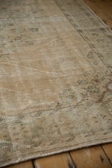 Patina on a vintage Distressed Oushak rug, revealing soft ivory and beige texture.