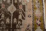 Close-up of distressed vintage Turkish Oushak runner, worn chocolate, blush, and olive floral motifs.