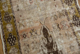 Distressed vintage Oushak rug detail with exposed knot heads, olive green border and faded blush tones.