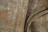Distressed pile texture with rhythmic geometric floral design in peach, ivory, and sandalwood.