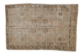 Distressed vintage Oushak rug with faded diamond medallion and subtle floral motifs, earthy, neutral tones, 3'1