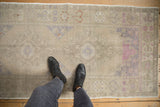 Distressed Oushak runner with abrashes, faded silver, dusty mauve, and terracotta patterns.