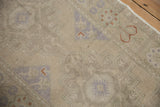 Distressed Oushak rug detail highlighting even wear, faint foundation, muted mauve geometric patterns.