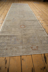 Worn pile texture and muted dusty mauve, terracotta, and silver geometric motifs.