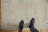 Soft, shaggy pile of a distressed Tulu rug with abstract plant motifs in pale blue and dusty mauve.
