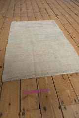 Vintage Turkish Tulu rug from an angle, showing its soft, evenly worn low pile.