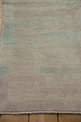 Evenly worn pile of a vintage Turkish Tulu rug showing low knot heads and pale tones.