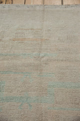 The evenly worn pile and visible hand-knotted texture of a distressed Turkish Tulu rug.