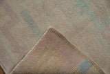 Corner of a vintage Tulu rug folded to show the hand-knotted pile and woven foundation.