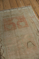 Vintage distressed Oushak rug showcasing its hand-knotted pile and subtle faded colors.
