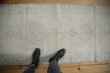 Distressed vintage Sparta runner with worn pile, faded ivory and pale blue Rococo medallions.