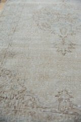 Worn pile texture revealing knot heads and foundation of the vintage Sparta rug.