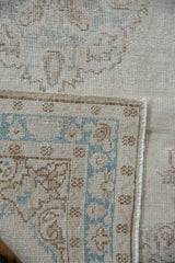 Distressed Sparta runner's worn pile, pale sky blue and coffee brown border design.