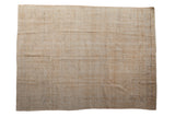 Distressed vintage Oushak carpet with heavy wear creating a textured aesthetic in dusty gold and beige tones.