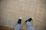 Textured aesthetic of a distressed vintage Oushak showing wear to the knot heads.