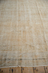 Diagonal striations and textural wear showing exposed knot heads on a vintage Oushak carpet.