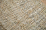 Distressed texture of the vintage Oushak carpet showing wear to the knot heads.