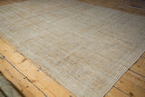 Textured wear and diagonal weaver lines on a distressed vintage Oushak carpet.