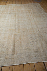 Angled close-up of the distressed rug's texture, showing wear to the knot heads.
