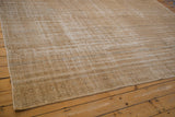 Distressed Oushak rug corner showing subtle faded motifs and visible foundation weave.