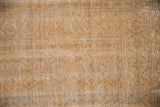 Textured pile of vintage distressed Oushak rug, showing beige, pale coffee, and silver tones.