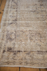Textured detail of the distressed Oushak rug's faded silver and charcoal patterns.