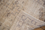 Distressed vintage Oushak rug showcasing worn pile texture and hand-knotted reverse in neutral tones.