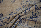 Distressed Oushak rug texture, faded navy patterns on cream, foundation exposed.