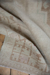 Distressed Oushak runner texture, with even pile wear and faint foundation showing.