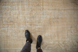 Distressed vintage Oushak rug texture with mostly even wear, exposed foundation, and faded motifs.