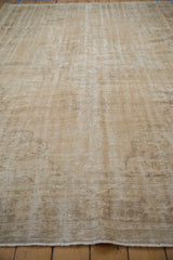 Distressed vintage Oushak texture, with mostly even wear, exposed foundation, cream hues.