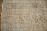 Distressed Oushak pile reveals low pile texture, subtle cream, coffee, and seafoam tones.