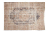 Decorative distressed Turkish Sparta rug with faded roundel medallion and muted floral sprays.