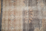 Distressed vintage Sparta rug texture, revealing faded floral sprays and visible foundation.