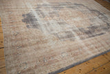 Distressed vintage Sparta carpet texture showing faded floral sprays in antique ivory and slate blue.