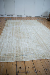 Distressed texture, visible foundation wear, and faint blue lines on the vintage Oushak rug.